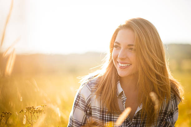 Authentic sunny portrait of young beautiful woman outdoor in nature