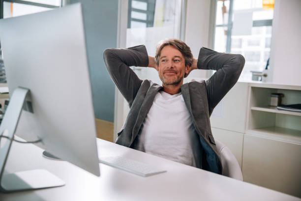 Executive mature man relaxing in office chair
