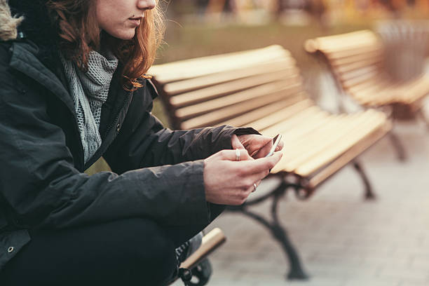 Cell phone break up Teenage girl feeling depressed after breaking up with her boyfriend through messages girl sitting stock pictures, royalty-free photos & images