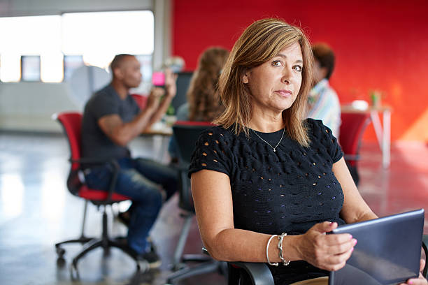 istock Confident female designer working on a digital tablet in red 517685250