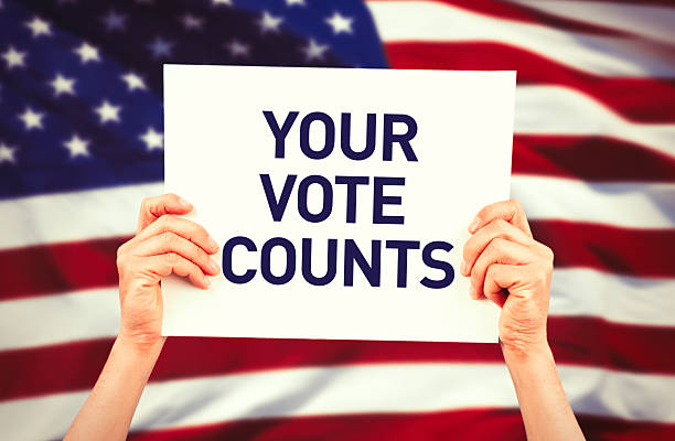 istock Hands holding slogan Your vote counts 517686394