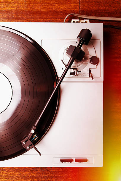 istock Hipster turntable playing vinyl record with music 517688164