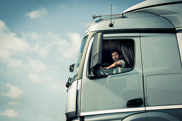 istock Truck driver sitting in cab 517694205