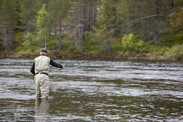 istock Fly fisherman in grey cap and vest. 517694793