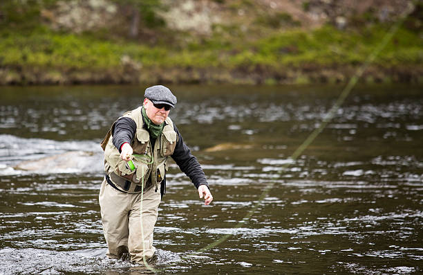 istock Fly fisherman grey cap sunglasses vest 517694795
