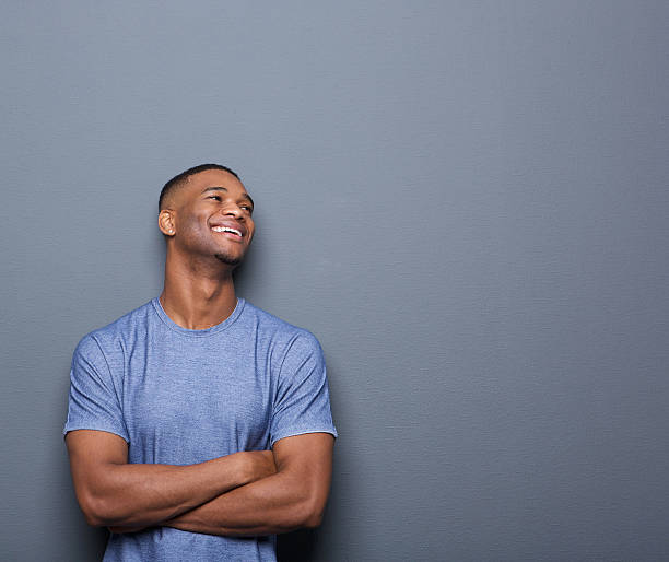 istock Happy african man laughing with arms crossed 517696837