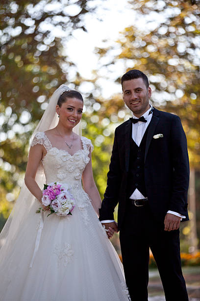 istock bride and groom in garden 517697069