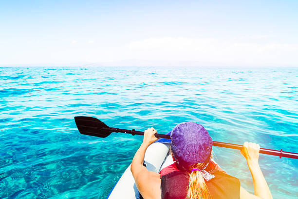 istock Young woman kayaking on open sea 517698331