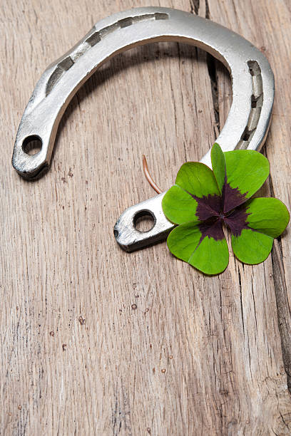 istock Horseshoe with a shamrock on old wooden 517699055