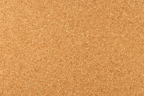 Close-up studio shot of cork board texture as background.