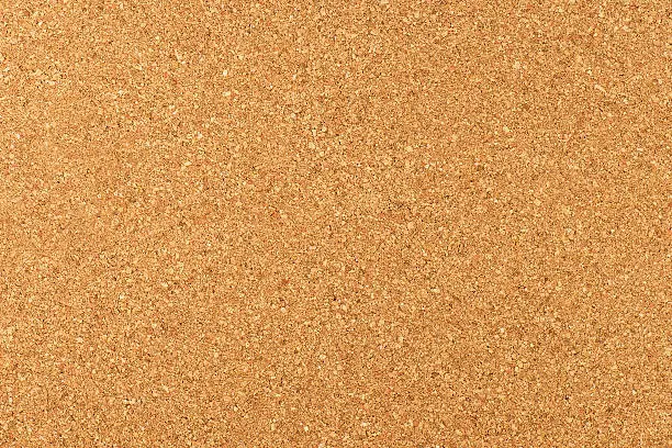 Close-up studio shot of cork board texture as background.