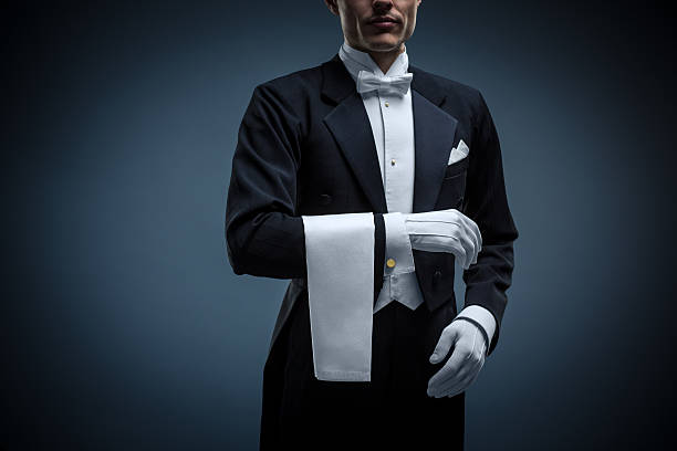 Waiter Waiter in a tuxedo on a black background glove stock pictures, royalty-free photos & images