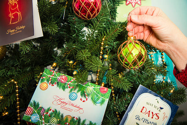istock Woman Hanging Ornaments On A Tree 517700363