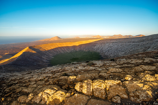 View on the crater of Caldera Blanca volcano on the sunset on Lanzarote island in Spain