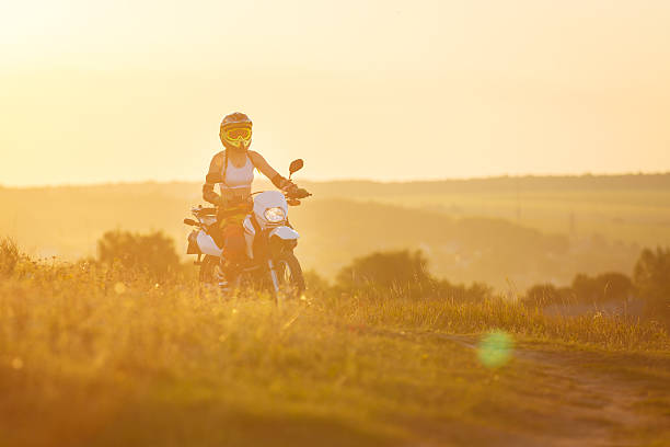 istock Woman biker in sunset, female motorcycle 517701448