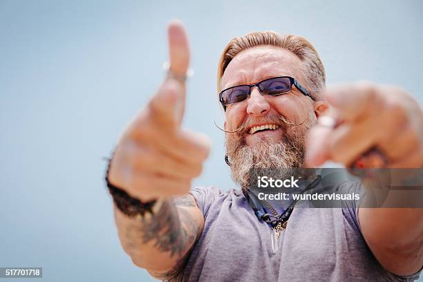 Smiling Goodnatured Man Looking Into The Camera Stock Photo - Download Image Now - Men, 50-54 Years, Humor