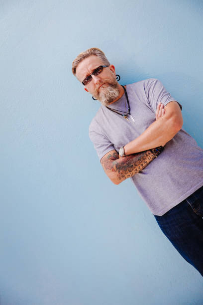 istock Expressive good looking mature man against blue wall 517702046