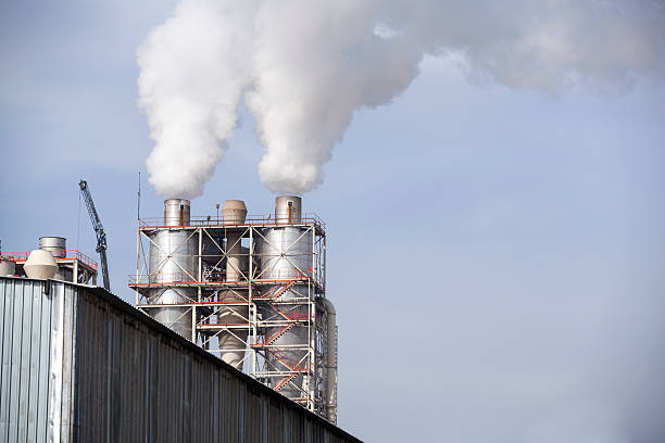 istock Industrial smoke from chimney on blue sky 517702062