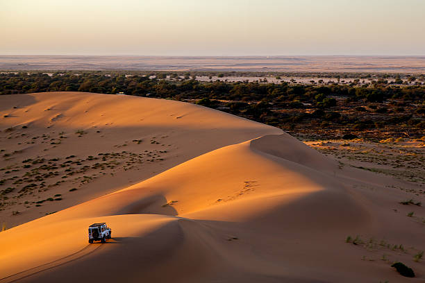 Life as opening A car is driving through sand dunes pick up truck photos stock pictures, royalty-free photos & images