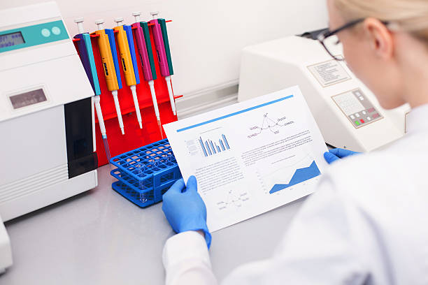istock Cheerful female researcher is working in laboratory 517703236