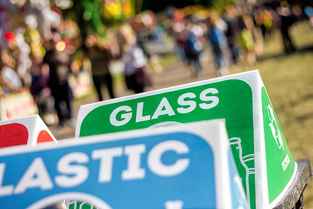 Several separate recycling bins for various materials at a music festival or other public event.