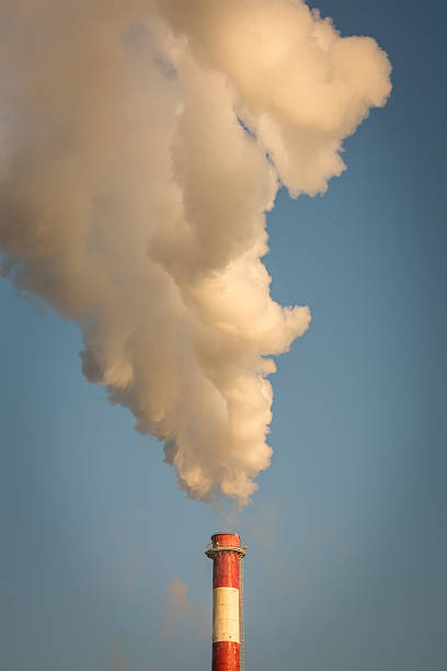 istock Smoke from the chimney and blue sky 517704038