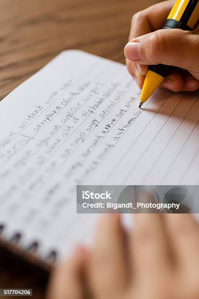 Child Writing By Hand On Notepad Stock Photo - Download Image Now - Boys, Child, Close-up