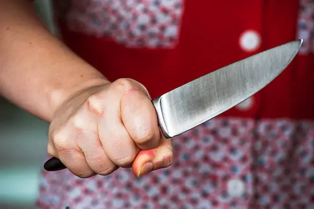 Woman hand holding big knife. Aggressive woman.