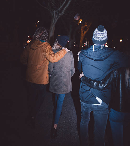 istock Young happy couples embracing while taking a night walk outside 517705800