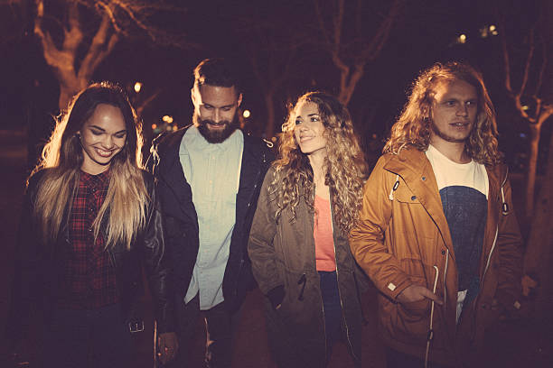 istock Young hipster friends walking in town on evening 517706082
