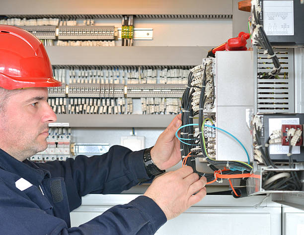 istock Profile of Tehnician with Red Hardhat Testing Equipment 517706788
