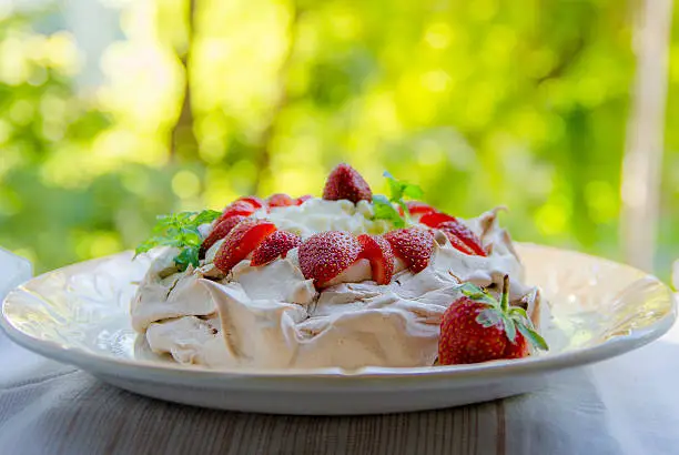 Famous meringue crispy cake Pavlova with strawberries