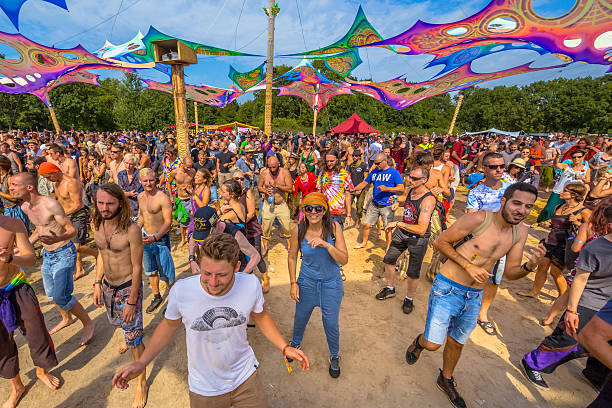 Leeuwarden, The Netherlands-August 30, 2015: Decoration, shoes, bicycle and people partying on the sandy dance floor at Psy-Fi open air psychedelic trance music Festival