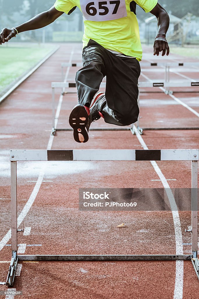 Young man during training in Hurdle Race Young man during training in Hurdle Race - focus on obstacle Activity Stock Photo