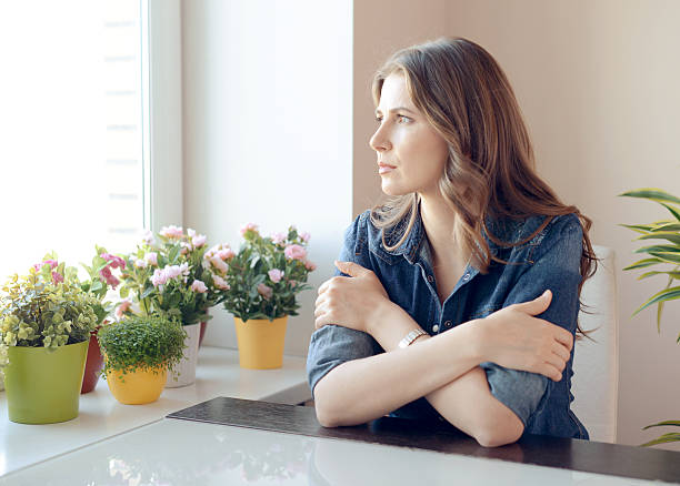 istock young beautiful woman sitting at the table 517713824