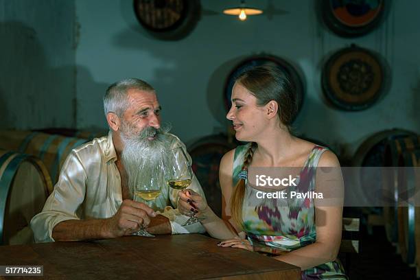 Senior Man With Beard And Young Woman In Cellar Europe Stock Photo - Download Image Now