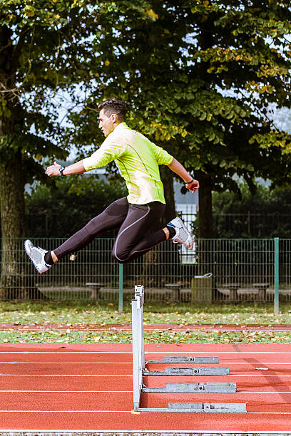 istock Young athlete jumping during training in Hurdle Race 517714393