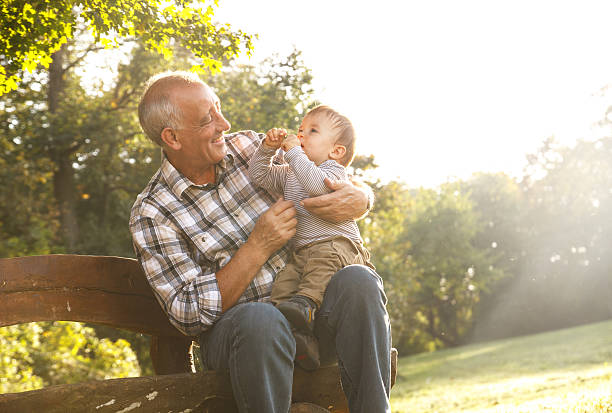 istock grandfather with grandson in park 517714593