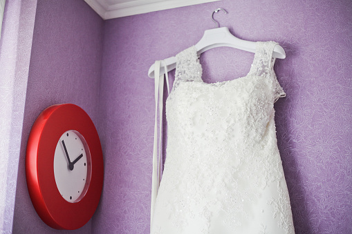 Wedding dress hanging on the wall and watch red 1
