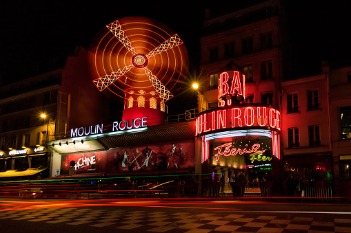 Paris, France- March 9, 2016: The Moulin Rouge by night in Paris, France. Moulin Rouge is a famous cabaret built in 1889, locating in the Paris red-light district of Pigalle