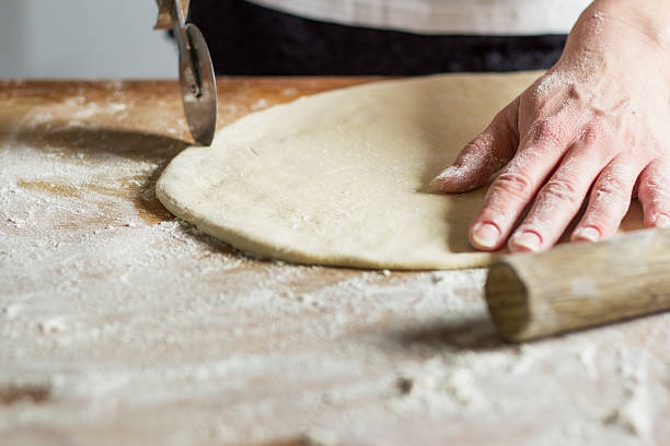 istock Woman making pasta from dough 517715800