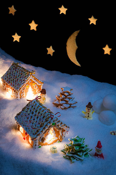 istock Snowy gingerbread village with stars and moon 517723337