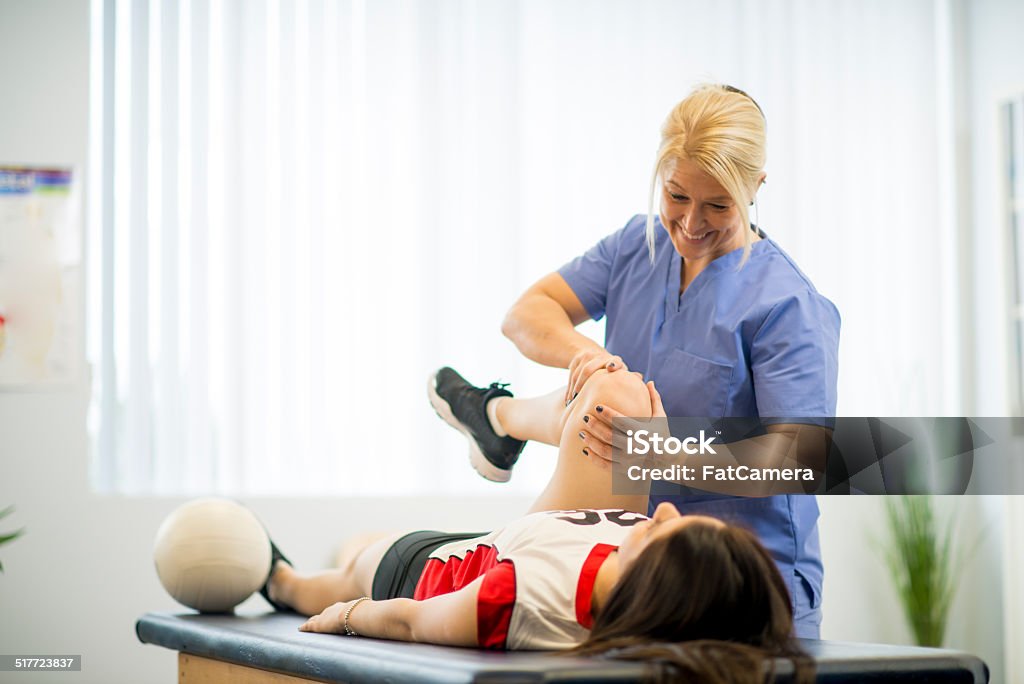 Physical Therapy An athlete receiving rehibilitative care for a sports injury. Doctor Stock Photo