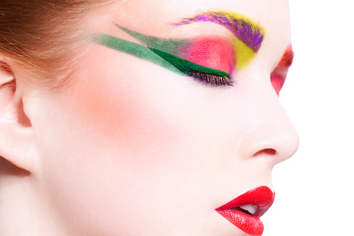Beautiful creative and colourful make-up. Close-up, profile of a woman's face with make-up.