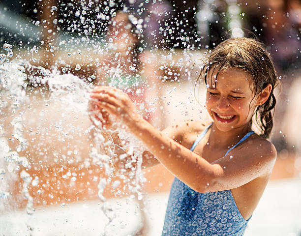 Little girl having fun in water park fountain Little girl having fun in water park fountain whites only drinking fountain stock pictures, royalty-free photos & images