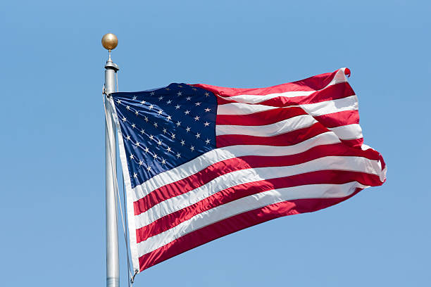 istock American flag on the blue sky 517727005