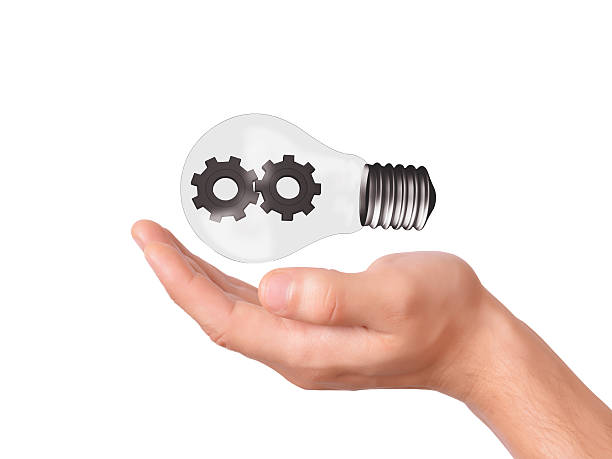 istock hand hold light bulb with gears. business concept 517727927