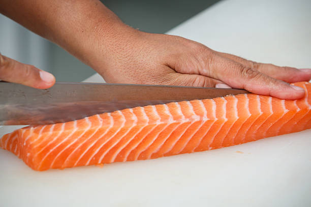 sliceing salmon stock photo