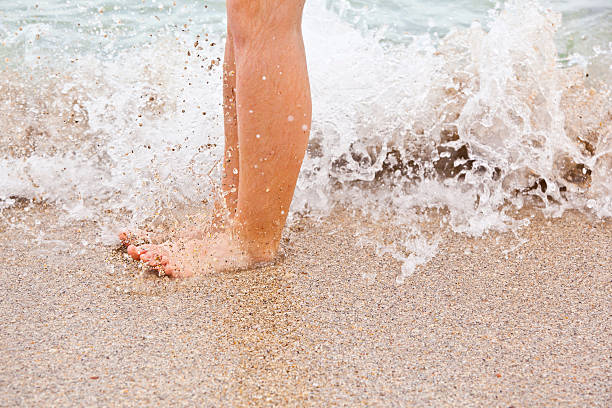 istock feet of boy running along the beach 517728267
