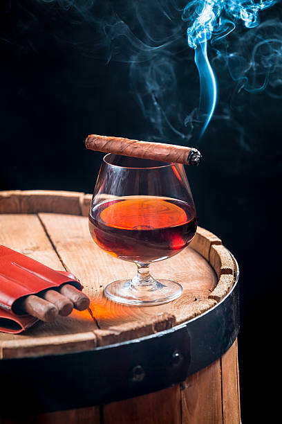 istock Aroma of Cuban cigars and cognac on black background 517729175